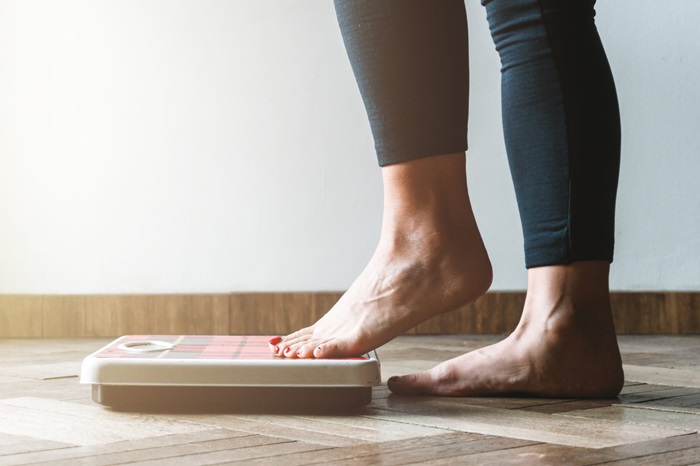 Woman Stepping on Scale