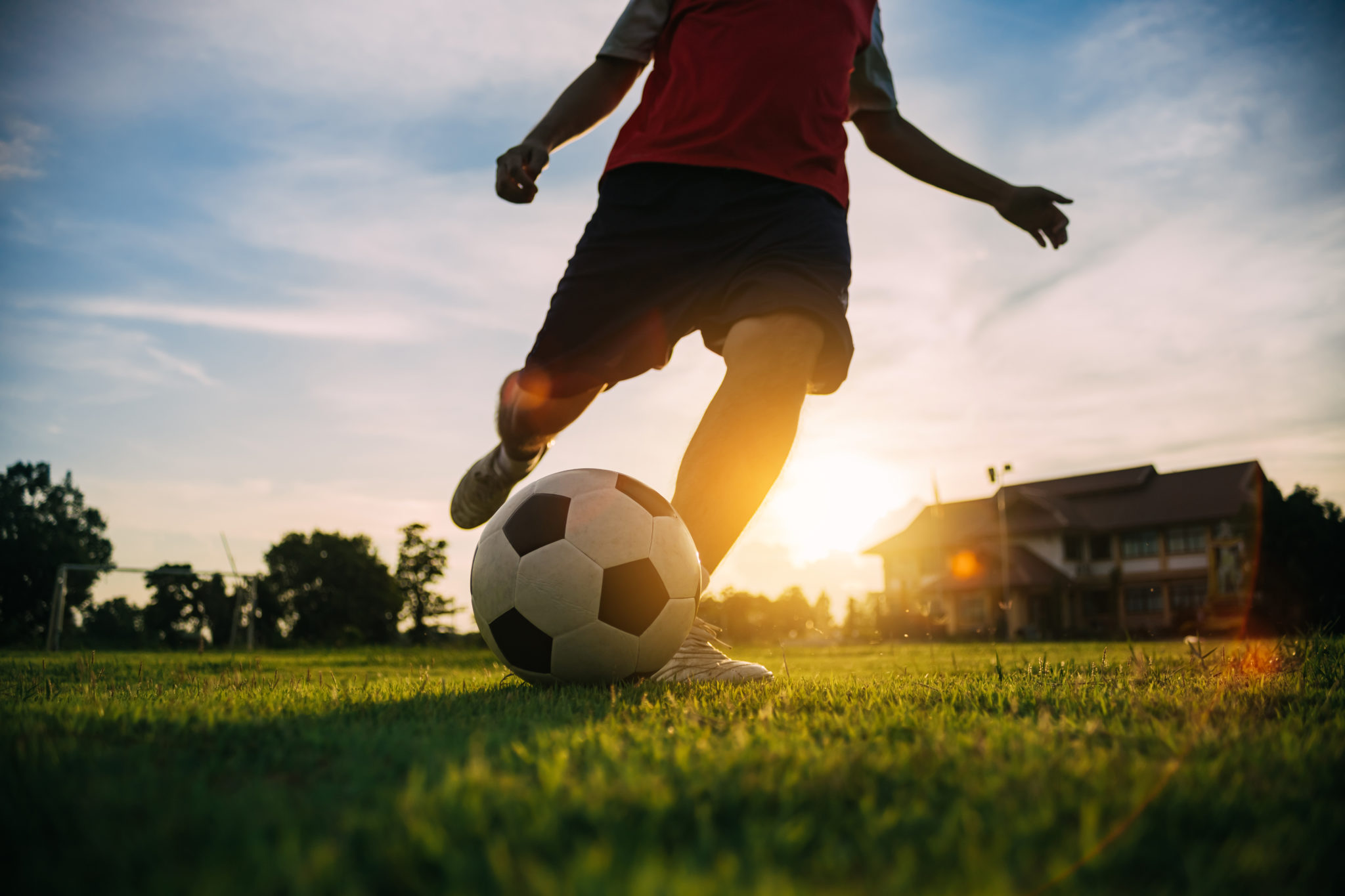 Person kicking soccer ball