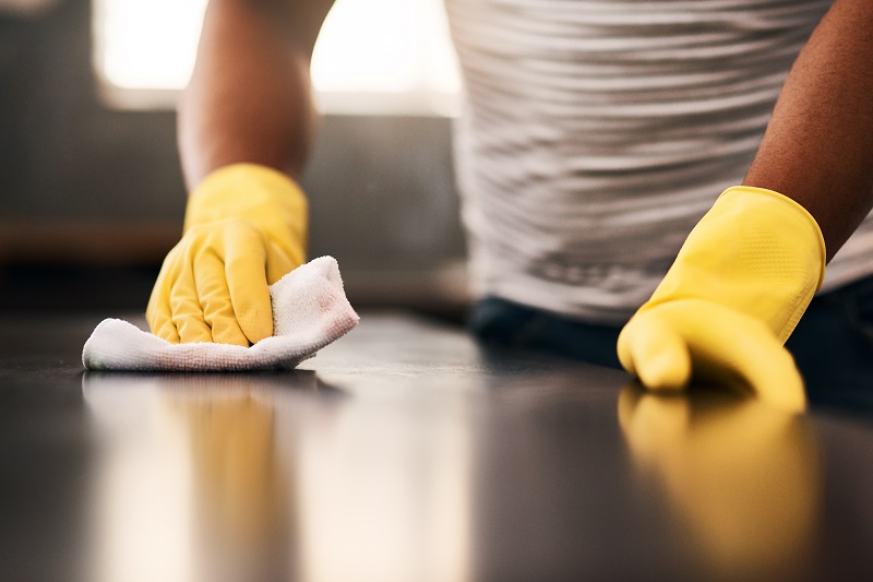 Close up of a counter being wiped down to clean off viruses, germs and monkeypox. 