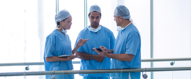 Group of surgeons wearing blue talking