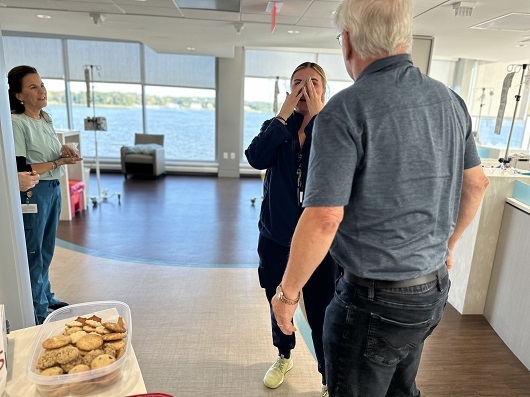 Albert interacting with nurses in the infusion center, one nurse emotional with his visit.