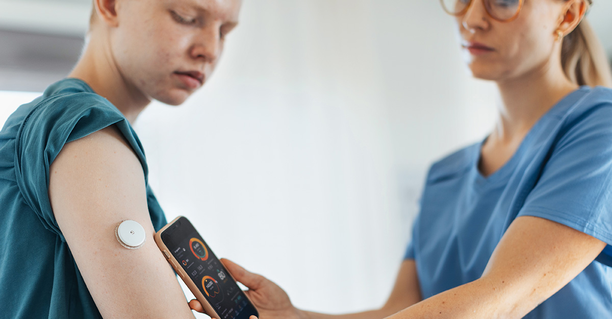 Doctor helping patient test CGM