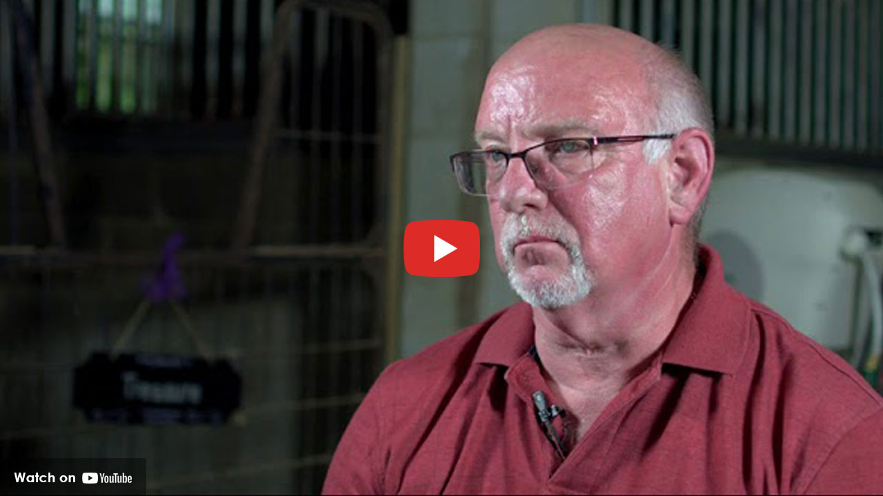 Man with red shirt and glasses talking about cardiac scan