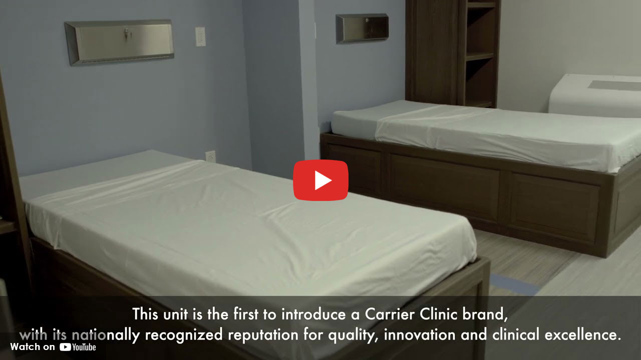 Two hospital beds inside a quiet behavioral health patient room