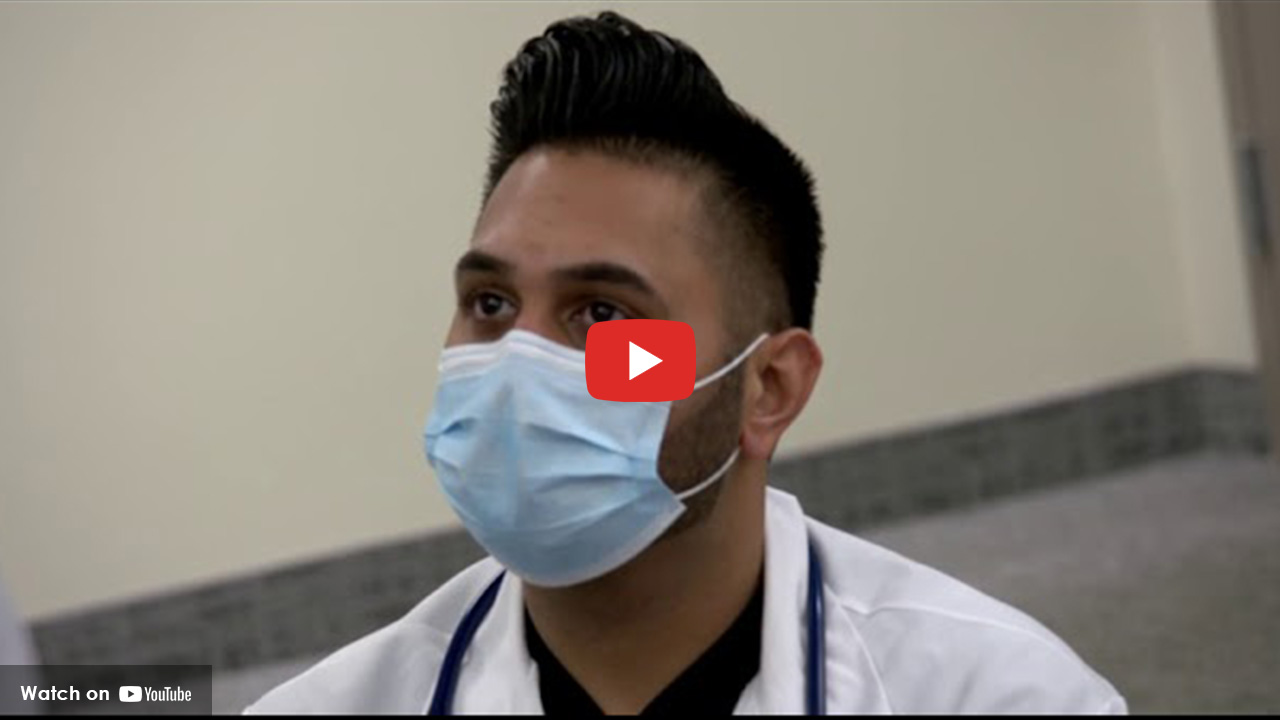 doctor wearing a face mask looking forward